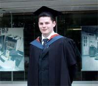 Ben Meadowcroft wearing graduation robes